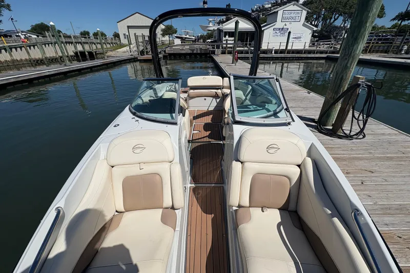 Slide: The Image of 2017 Crownline 275 SS boat docked, featuring spacious seating and sleek design. - 11
