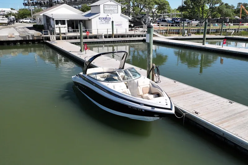 Slide: The Image of 2017 Crownline 275 SS boat docked at marina near Sloop Point Market. - 2