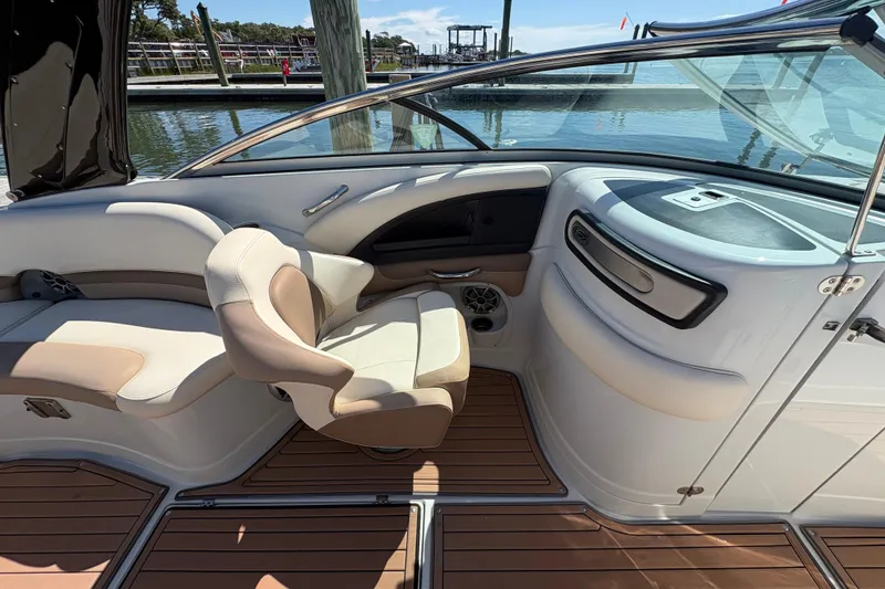 Slide: The Image of 2017 Crownline 275 SS boat interior with beige seating and wood flooring. - 20