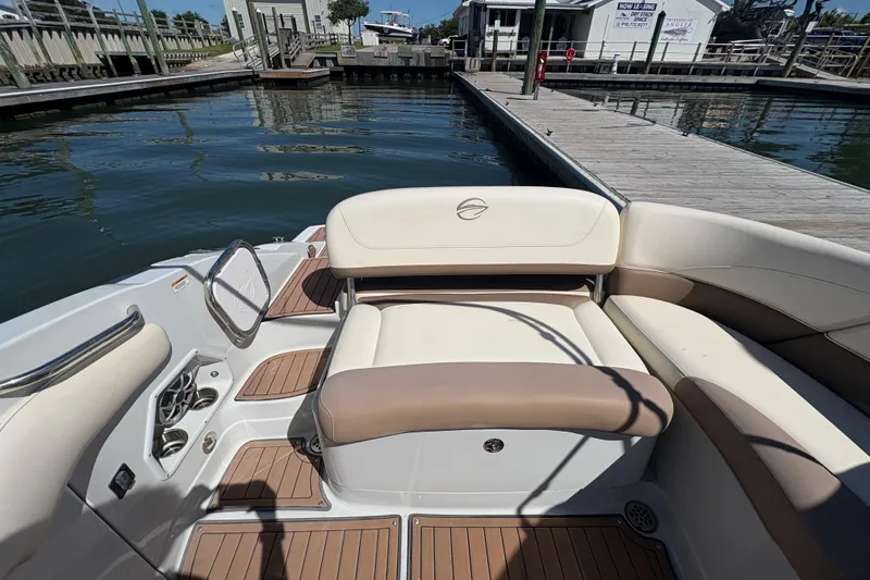 Slide: The Image of 2017 Crownline 275 SS boat interior with seating and dock view. - 26