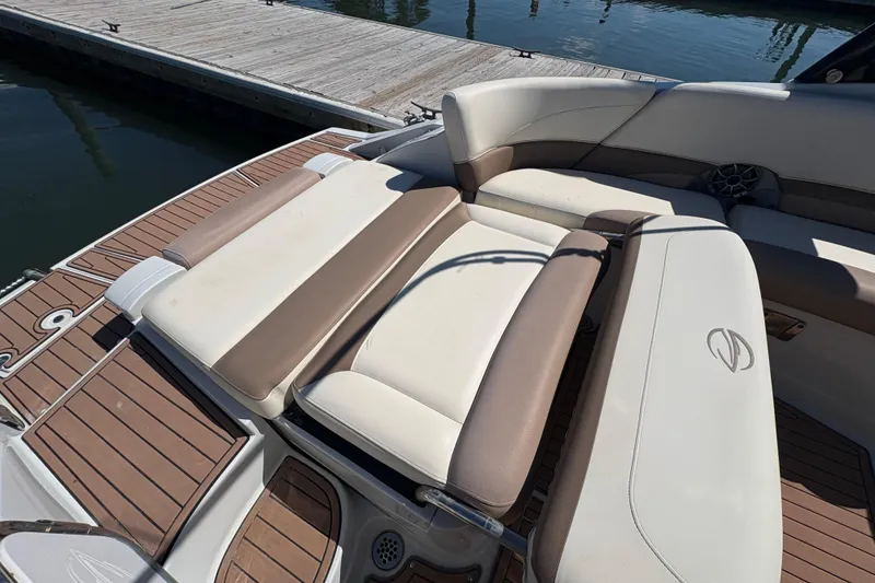 Slide: The Image of 2017 Crownline 275 SS boat interior with cushioned seating and wooden deck. - 28