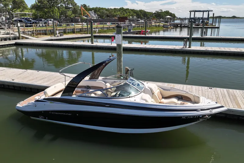 Slide: The Image of 2017 Crownline 275 SS boat docked at a marina, featuring sleek design and comfortable seating. - 3