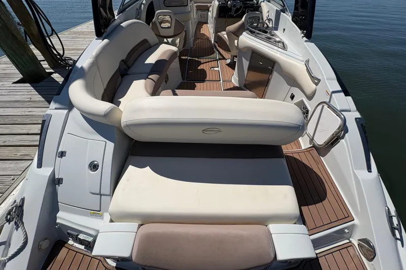 Slide: The Image of 2017 Crownline 275 SS boat interior with luxurious seating and wooden flooring. - 30