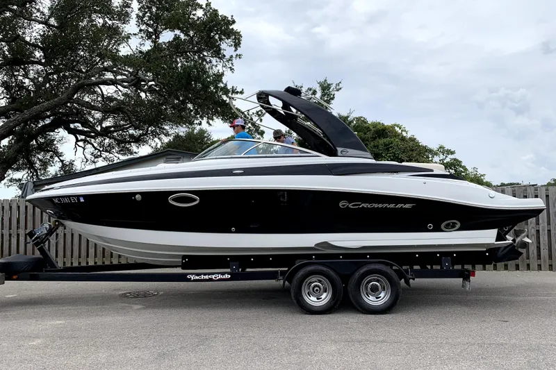 Slide: The Image of 2017 Crownline 275 SS boat on trailer, parked outdoors under cloudy sky. - 31