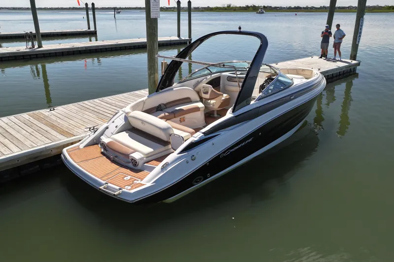 Slide: The Image of 2017 Crownline 275 SS boat docked at marina, featuring sleek design and spacious seating. - 4