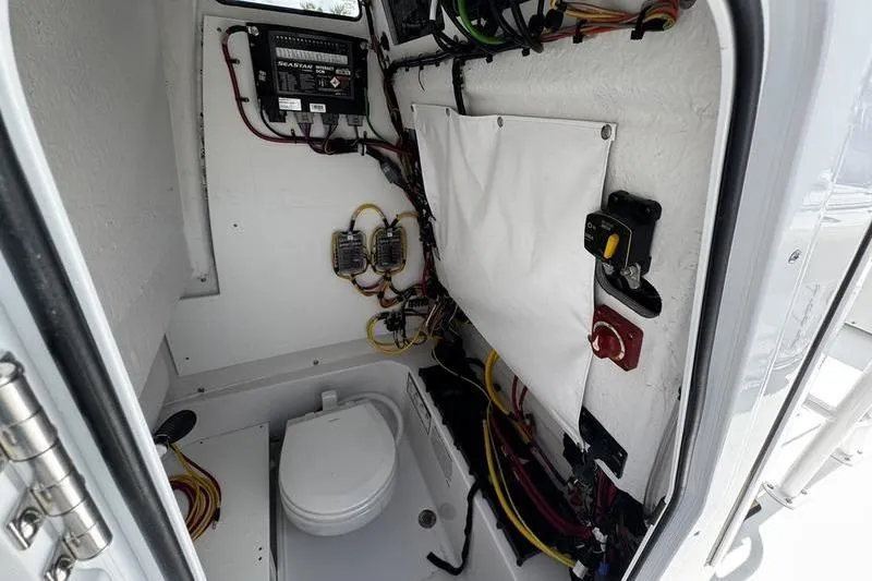 Slide: The Image of Interior of 2026 Sportsman Open 232 Center Console boat, featuring wiring and equipment. - 11