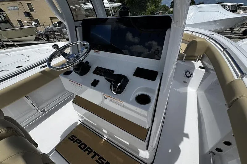 Slide: The Image of 2026 Sportsman Open 232 Center Console boat interior with steering wheel and control panel. - 13