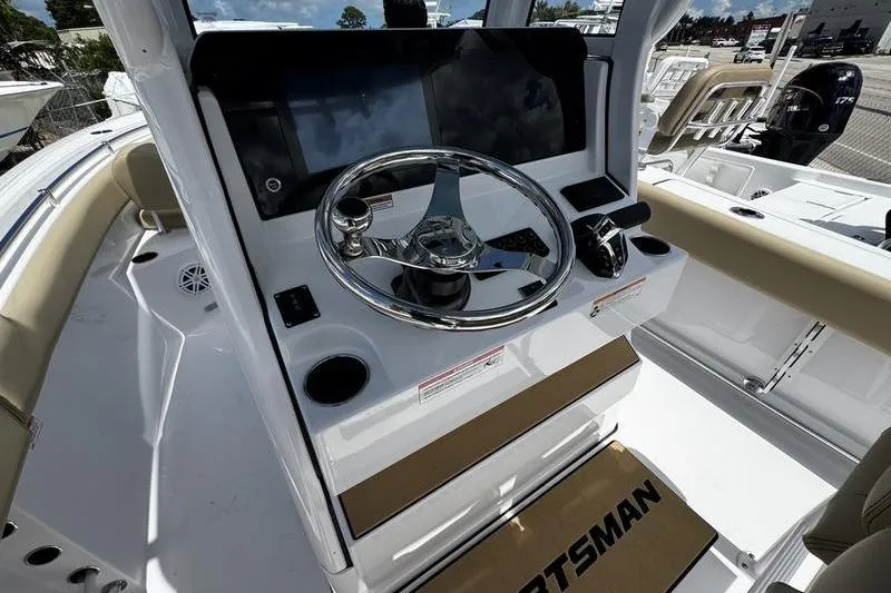 Slide: The Image of 2026 Sportsman Open 232 Center Console boat interior with steering wheel and controls. - 16