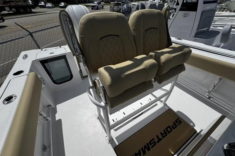 Slide: The Image of 2026 Sportsman Open 232 Center Console boat with tan seating and white deck. - 17