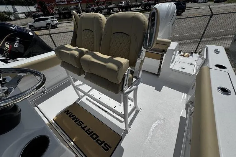 Slide: The Image of 2026 Sportsman Open 232 Center Console boat interior with beige seating and steering wheel. - 18