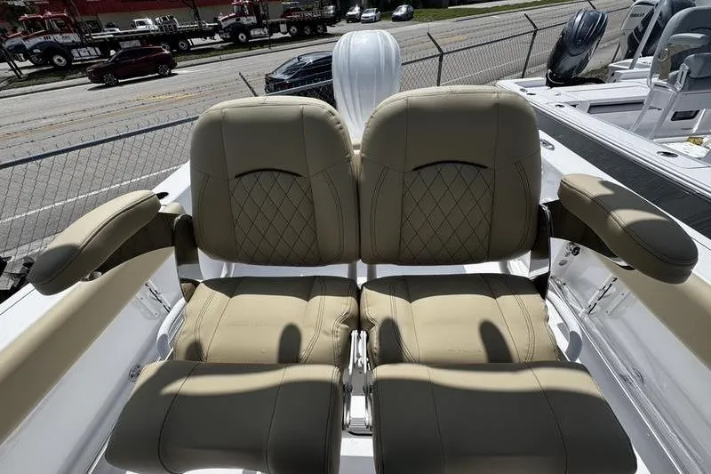 Slide: The Image of 2026 Sportsman Open 232 Center Console boat seats with beige upholstery and diamond stitching. - 19