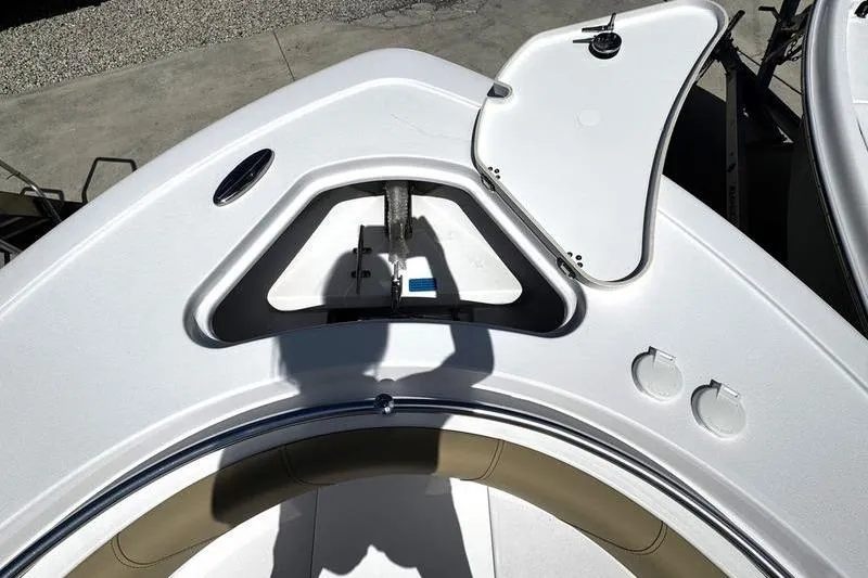 Slide: The Image of 2026 Sportsman Open 232 Center Console boat deck with open storage compartment. - 2