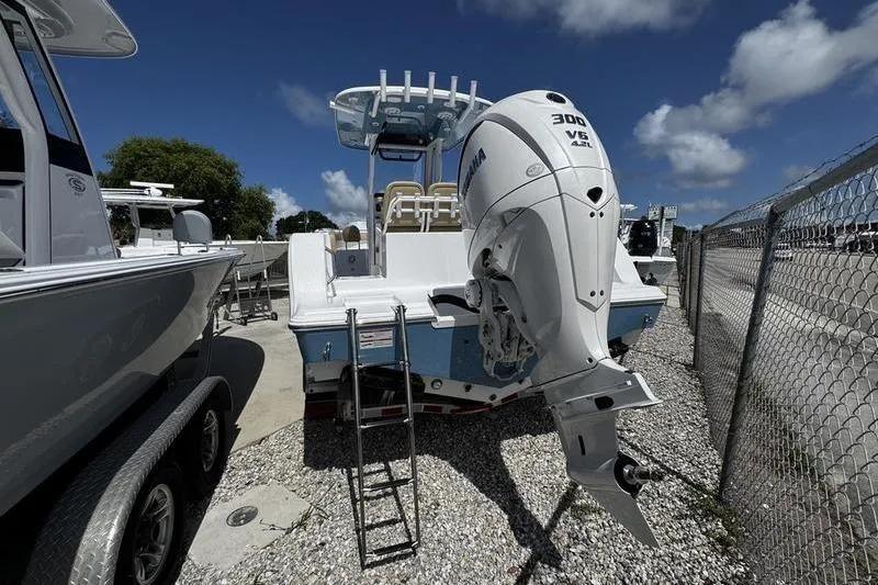 Slide: The Image of 2026 Sportsman Open 232 Center Console boat with Yamaha 300 V6 engine, parked outdoors. - 25