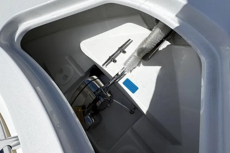 Slide: The Image of Anchor compartment of 2026 Sportsman Open 232 Center Console boat, featuring cleats and anchor system. - 3