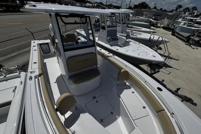 Slide: The Image of 2026 Sportsman Open 232 Center Console boat displayed in a marina, showcasing sleek design. - 7