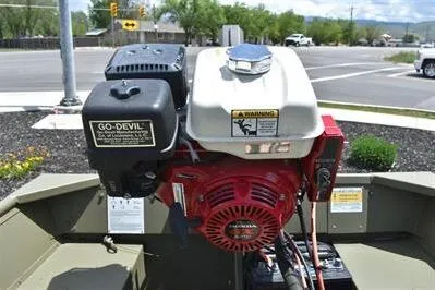 Slide: The Image of 2024 Lowe L1240 Jon boat with Go-Devil engine, parked outdoors. - 8