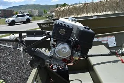 Slide: The Image of 2024 Lowe L1240 Jon boat with motor, parked outdoors on a sunny day. - 9
