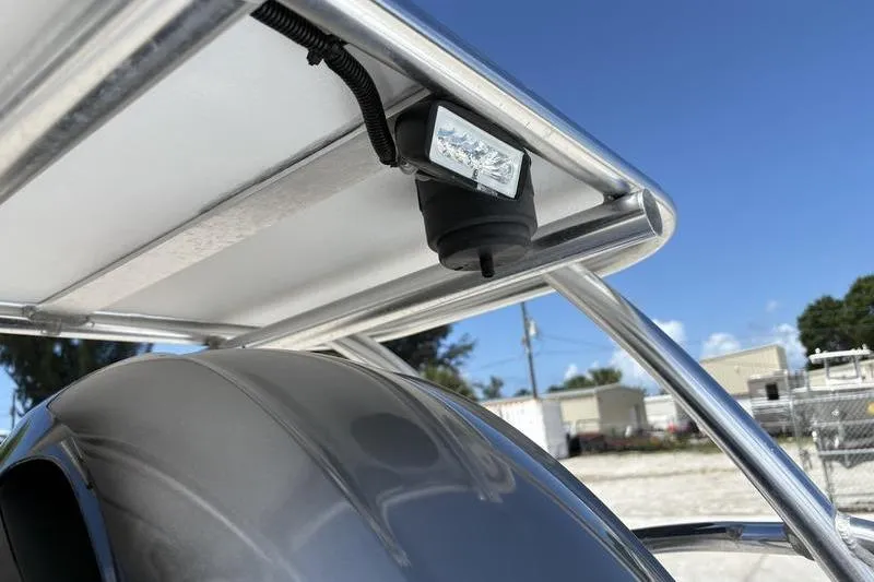 Slide: The Image of 2022 East Cape Vantage boat with mounted light under canopy, clear sky background. - 16