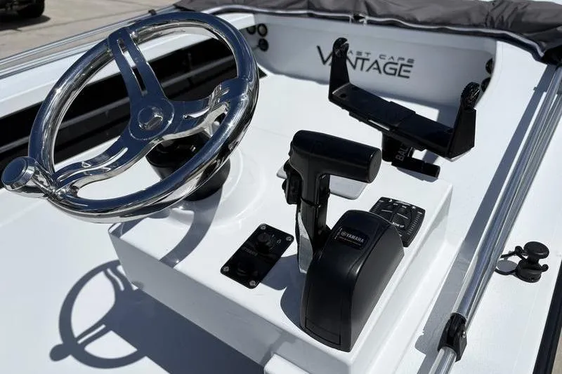 Slide: The Image of 2022 East Cape Vantage boat console with steering wheel and controls. - 17