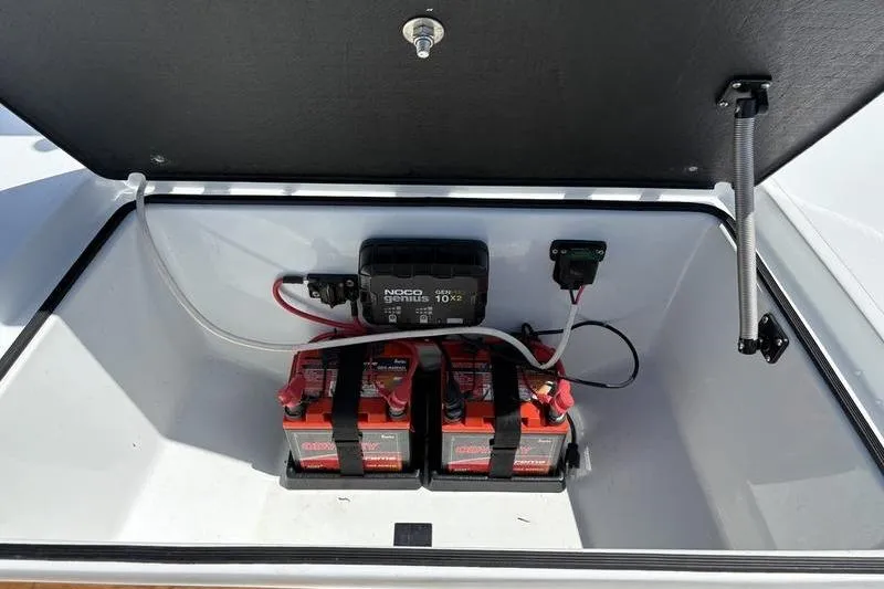 Slide: The Image of Open battery compartment of 2022 East Cape Vantage boat with dual batteries and charger. - 22