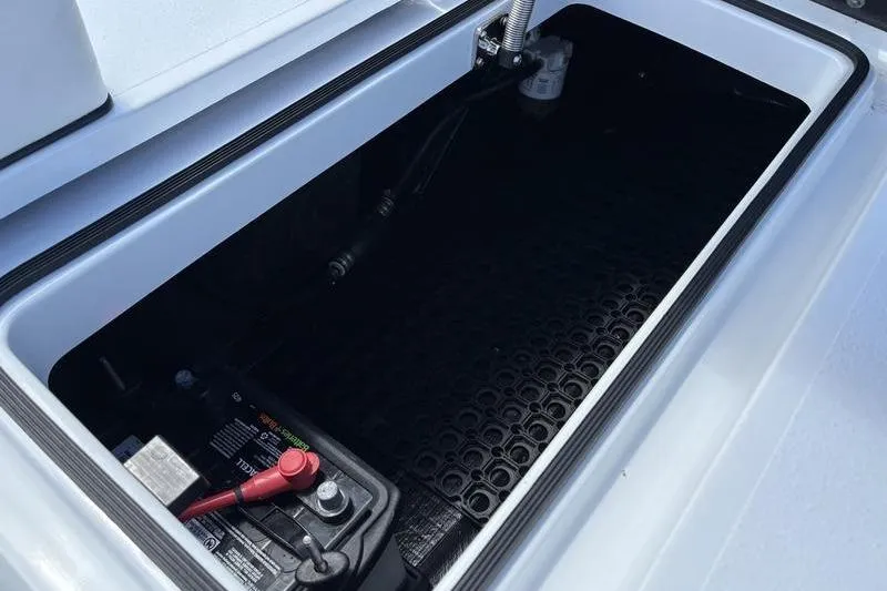 Slide: The Image of 2022 East Cape Vantage boat storage compartment with battery and wiring. - 23