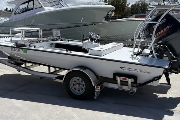 Slide: The Image of 2022 East Cape Vantage boat on trailer, parked outdoors with Yamaha outboard motor. - 25