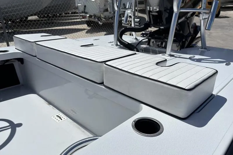 Slide: The Image of 2022 East Cape Vantage boat interior with cushioned seating and Yamaha 115 engine. - 4