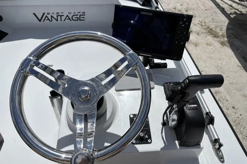 Slide: The Image of Steering wheel and controls of 2022 East Cape Vantage boat with Simrad display. - 7