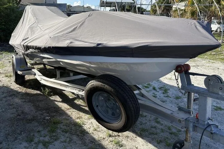 Slide: The Image of 2022 East Cape Vantage boat covered on trailer, parked outdoors. - 9