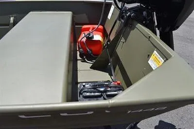 Slide: The Image of 2024 Lowe L1448 Jon boat interior with motor and fuel tank. - 10