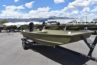 Slide: The Image of 2024 Lowe L1448 Jon boat on trailer under blue sky with clouds. - 3