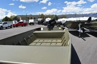 Slide: The Image of 2024 Lowe L1448 Jon boat on trailer, parked outdoors under a clear sky. - 9