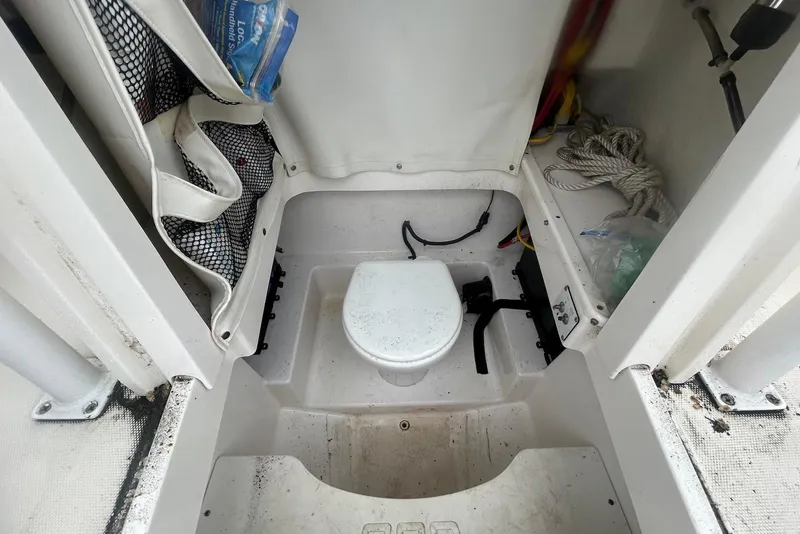 Slide: The Image of 2016 Wellcraft 242 Fisherman boat interior with toilet and storage compartments. - 10