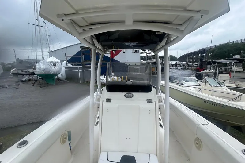 Slide: The Image of 2016 Wellcraft 242 Fisherman boat docked at a marina on a cloudy day. - 6