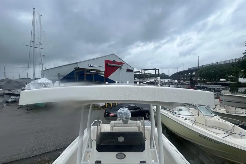 Slide: The Image of 2016 Wellcraft 242 Fisherman boat docked at marina on a cloudy day. - 7