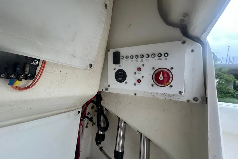 Slide: The Image of Control panel of a 2016 Wellcraft 242 Fisherman boat, featuring switches and wiring. - 8