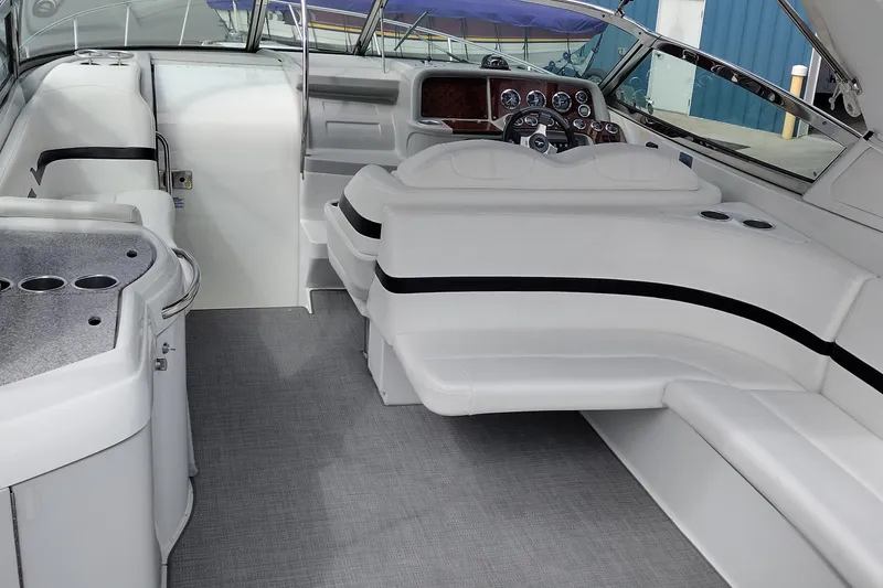 Slide: The Image of Interior of a 2005 Formula 330 Sun Sport boat with white seating and dashboard. - 12