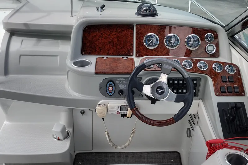 Slide: The Image of Dashboard of a 2005 Formula 330 Sun Sport boat with steering wheel and gauges. - 14