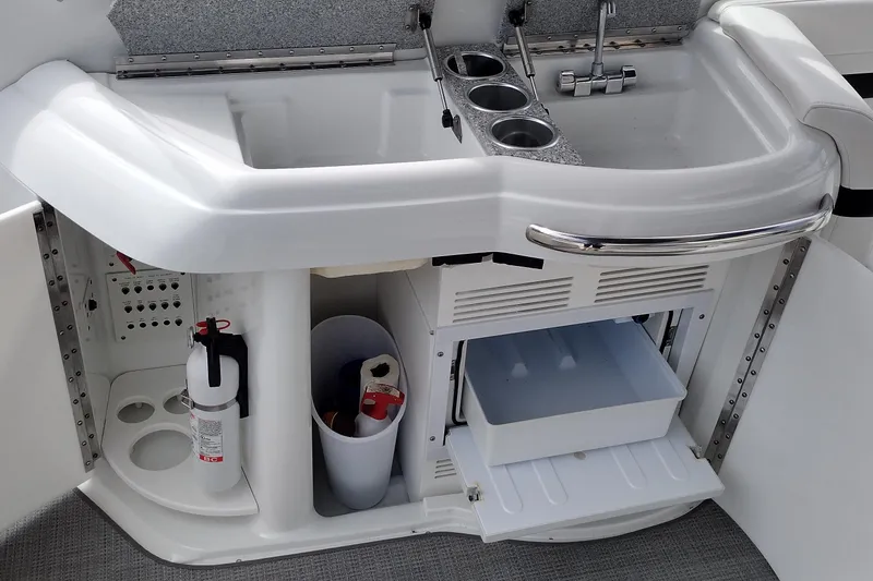 Slide: The Image of 2005 Formula 330 Sun Sport boat kitchenette with sink, storage, and fire extinguisher. - 17