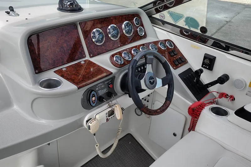 Slide: The Image of Dashboard of a 2005 Formula 330 Sun Sport boat with steering wheel and gauges. - 18