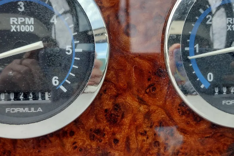 Slide: The Image of Close-up of 2005 Formula 330 Sun Sport RPM gauges on a wood grain dashboard. - 22