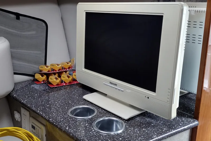 Slide: The Image of 2005 Formula 330 Sun Sport interior with TV and countertop accessories. - 28