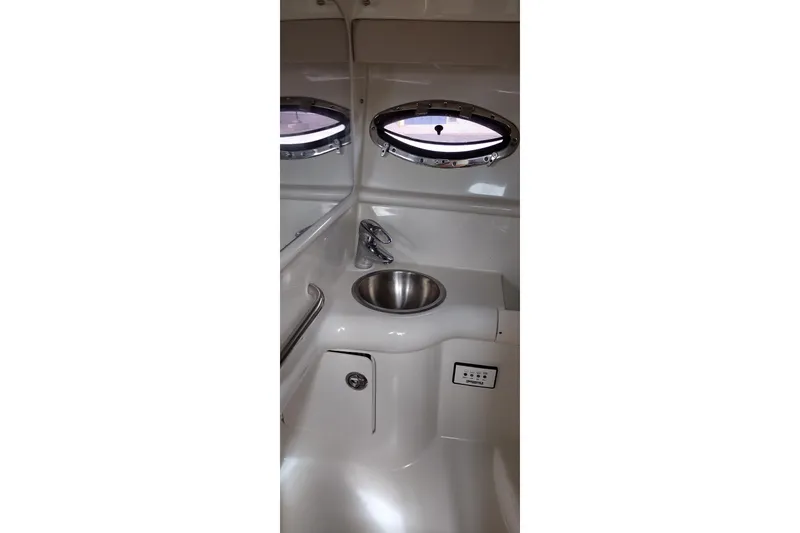 Slide: The Image of Interior of 2005 Formula 330 Sun Sport boat featuring a compact sink and portholes. - 31