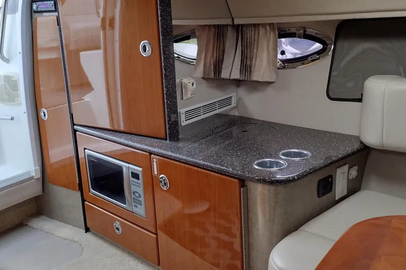 Slide: The Image of 2005 Formula 330 Sun Sport interior with kitchenette, featuring microwave and countertop. - 33