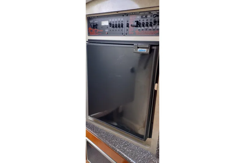 Slide: The Image of Control panel and refrigerator in 2005 Formula 330 Sun Sport boat interior. - 35