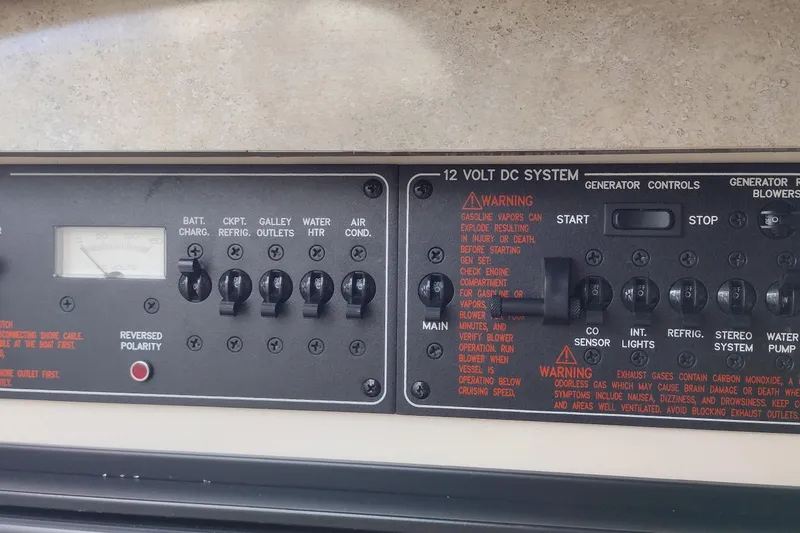Slide: The Image of Control panel of a 2005 Formula 330 Sun Sport boat with various switches and warnings. - 36