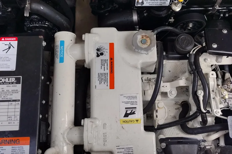 Slide: The Image of Engine compartment of a 2005 Formula 330 Sun Sport boat with warning labels. - 45
