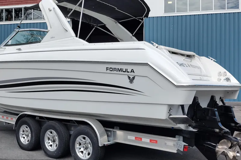 Slide: The Image of 2005 Formula 330 Sun Sport boat on trailer, side view with sleek design. - 7