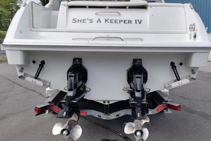 Slide: The Image of 2005 Formula 330 Sun Sport boat rear view with dual propellers and "She's A Keeper IV" name. - 8