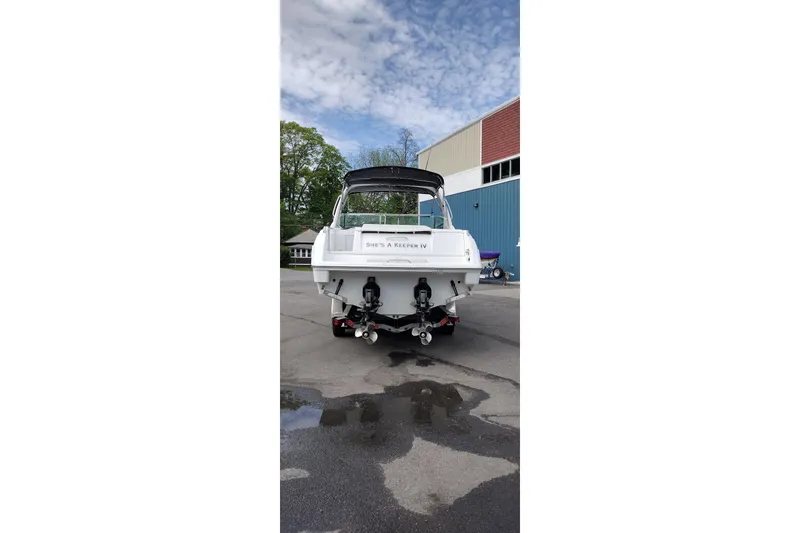 Slide: The Image of 2005 Formula 330 Sun Sport boat, rear view, parked outdoors on a cloudy day. - 9